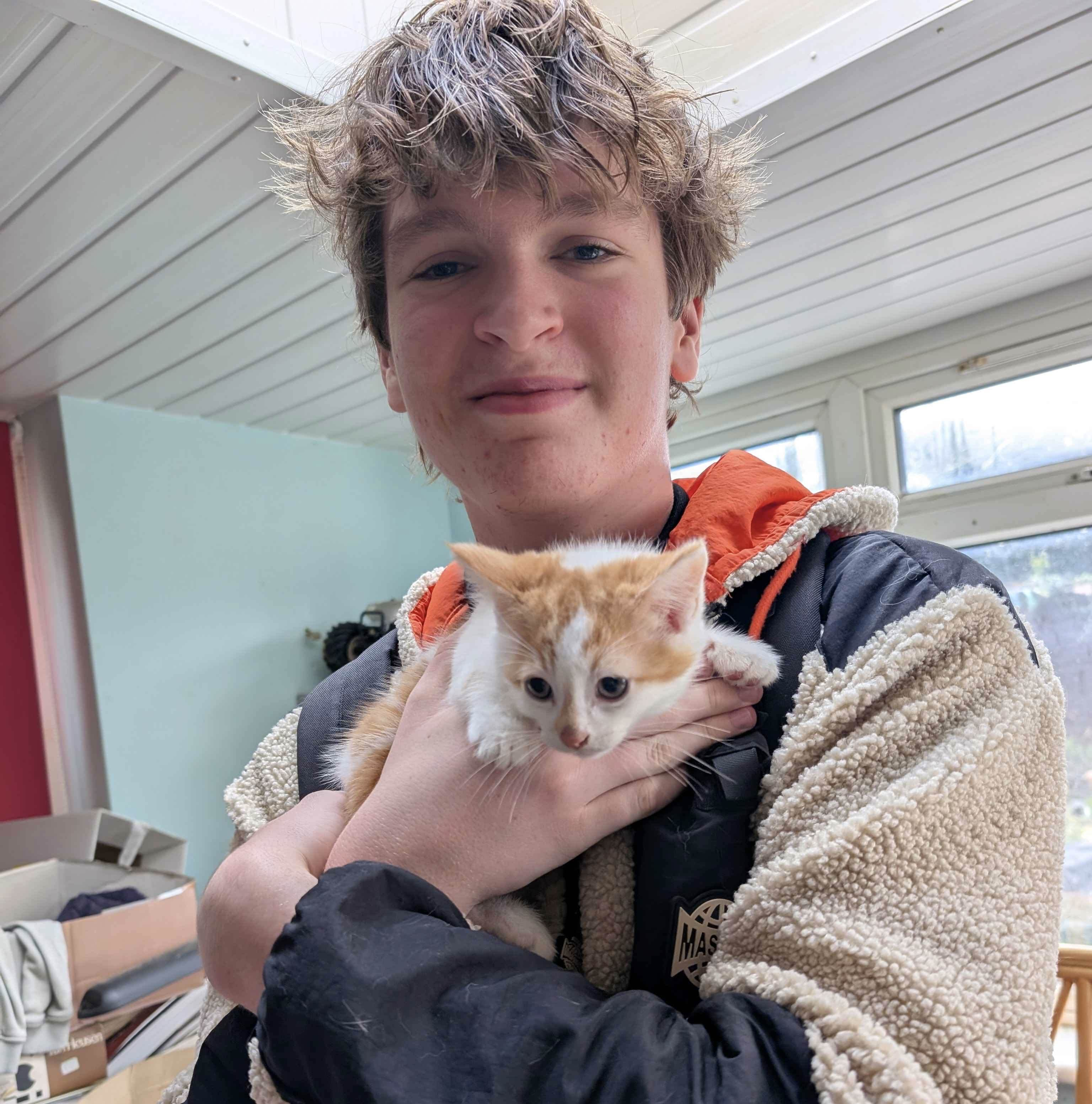 Portrait of Billy holding a kitten